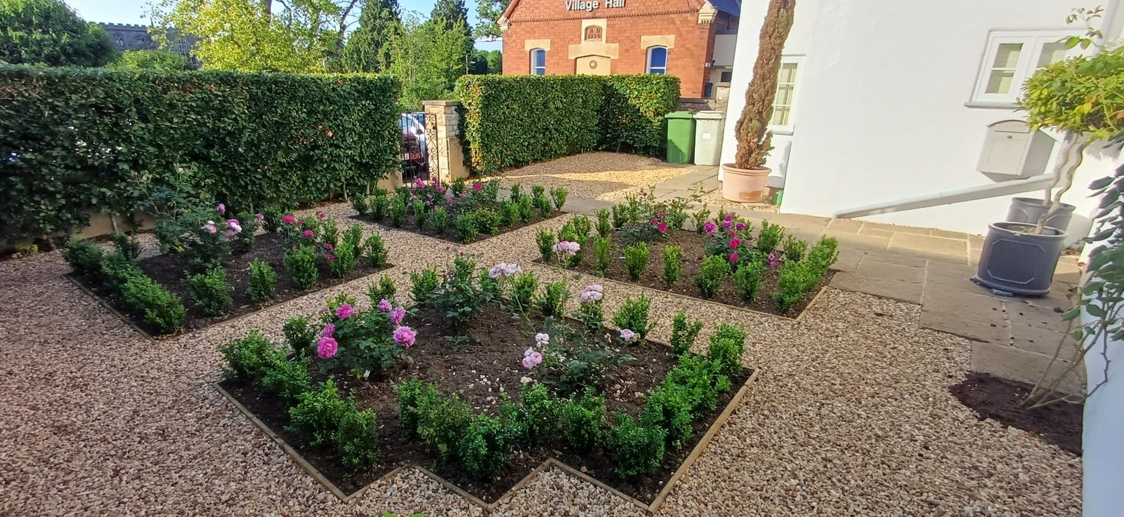 The same cottage garden after: parterre beds, box hedging and roses